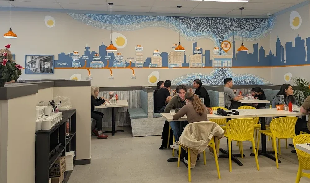 Customers enjoying breakfast and lunch inside a Yolks restaurant, representing franchise vs independent restaurant concepts