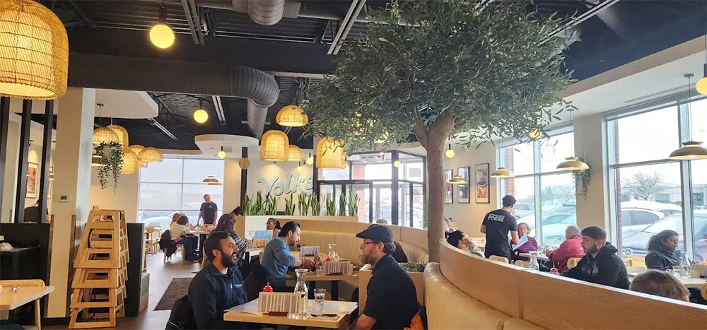 Interior of Yolks DDO restaurant in Dollard-des-Ormeaux Quebec with guests enjoying breakfast and lunch