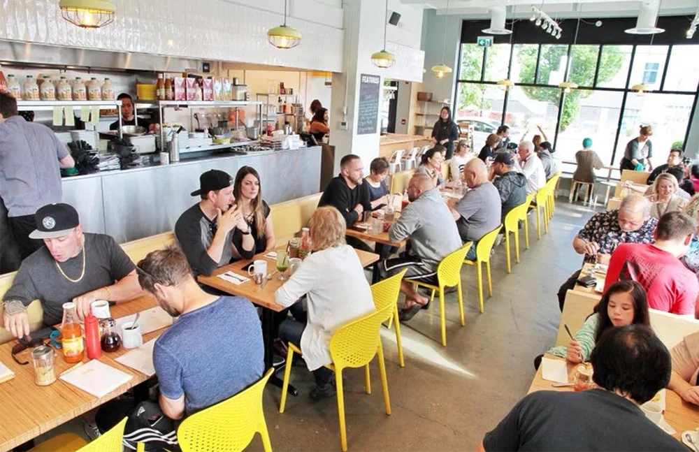 Guests enjoying breakfast inside a busy Yolks restaurant as the brand continues to grow across Canada