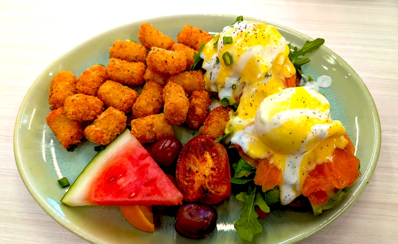 Smoked salmon eggs benedict and breakfast potatoes served at Yolks in Bloor West Village near High Park.
